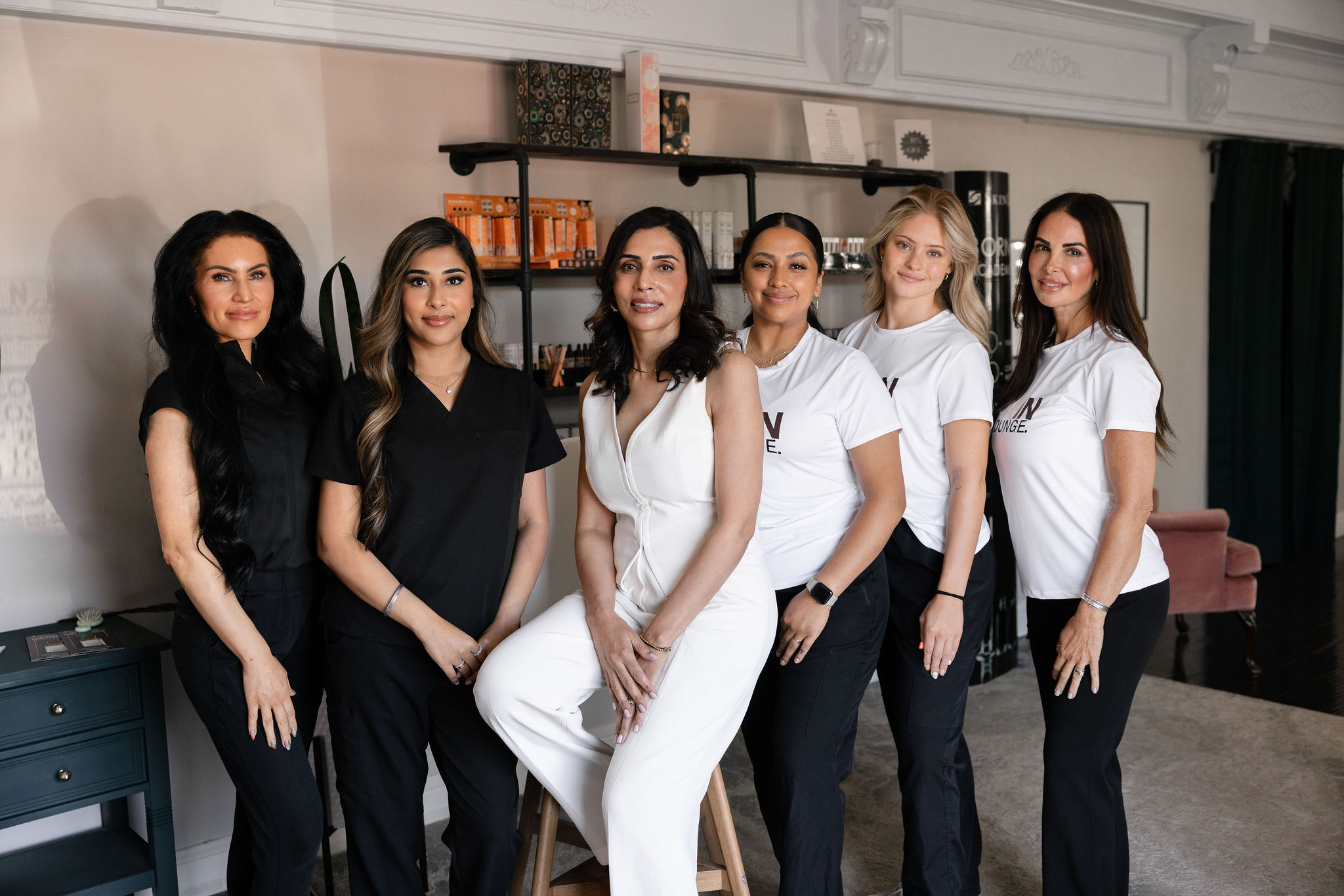 The team at Younger You Aesthetics — six providers, owner Su Mann center